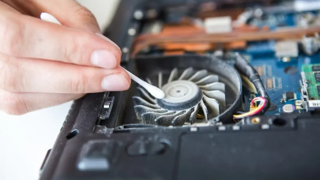 imgi 2 Person cleaning dust out of a laptop